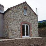 Tumbled Tipperary Sandstone With Rock Faced Limestone Cills, Red Brick Door Arch