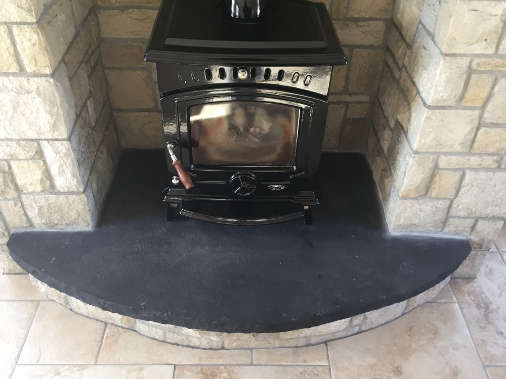 Curved rock faced limestone hearth