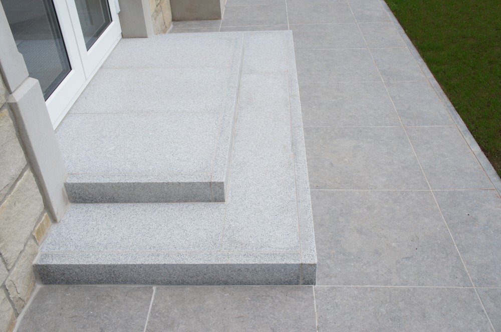 Steps formed using silver granite flamed kerbs with silver granite paving treads